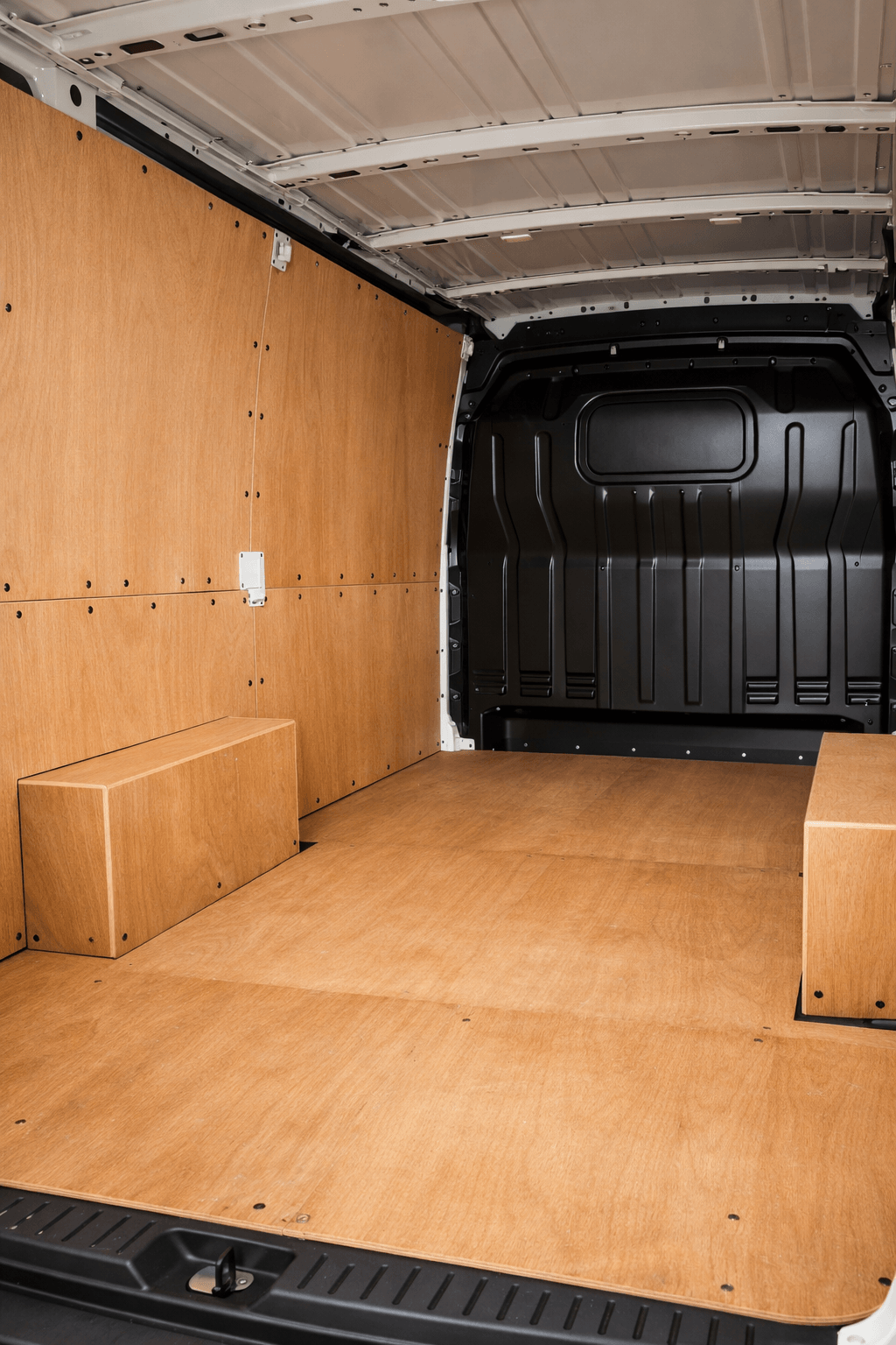 Interior of a van load area showing clean, intact ply lining panels fitted to the walls